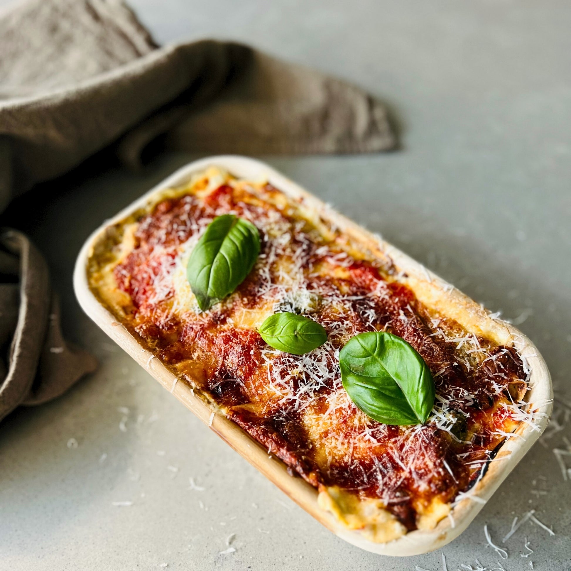 Spinach and ricotta crespelle baked in tomato sauce – Italian meal delivery Northern Rivers