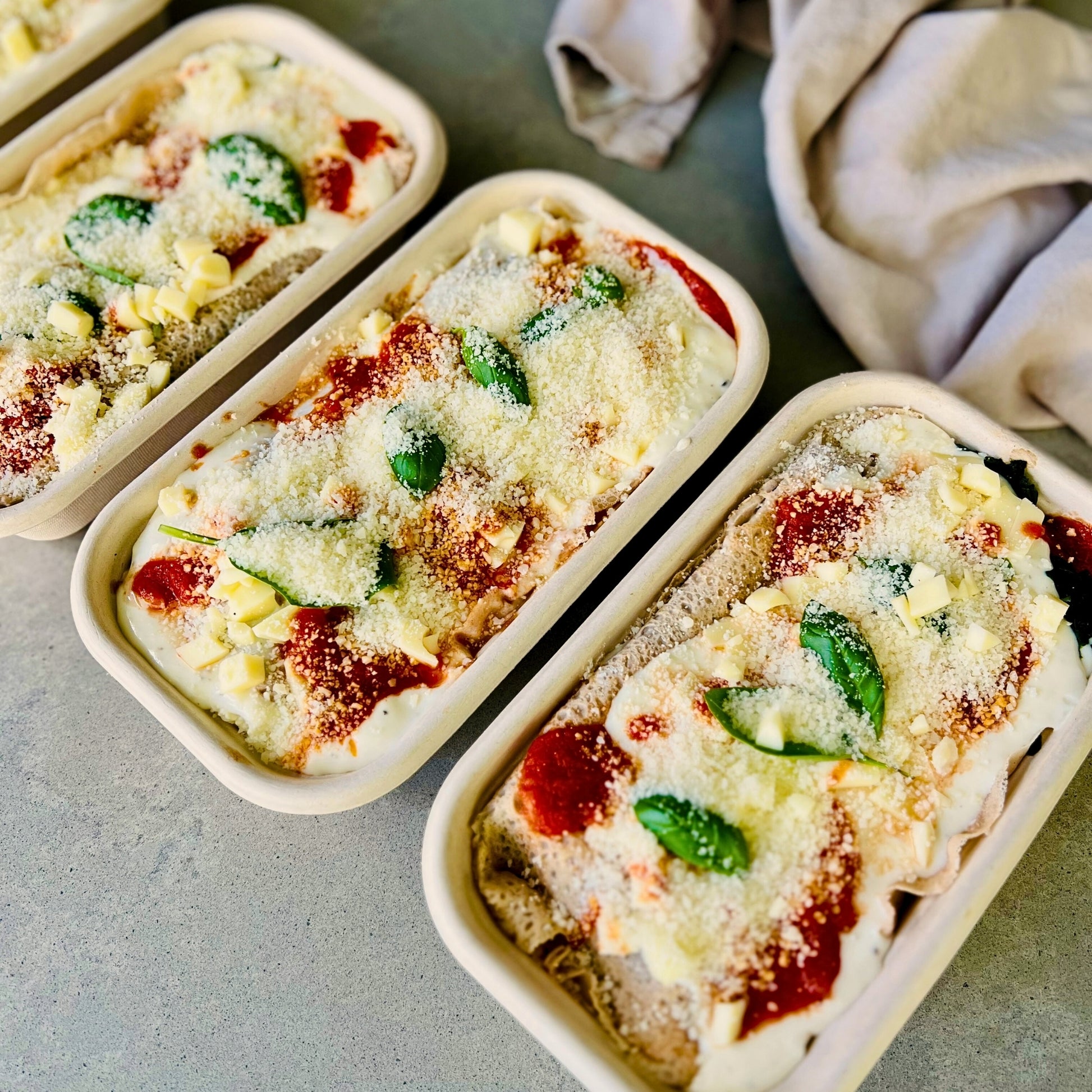 Spinach and ricotta crespelle baked in tomato sauce – Italian meal delivery Northern Rivers